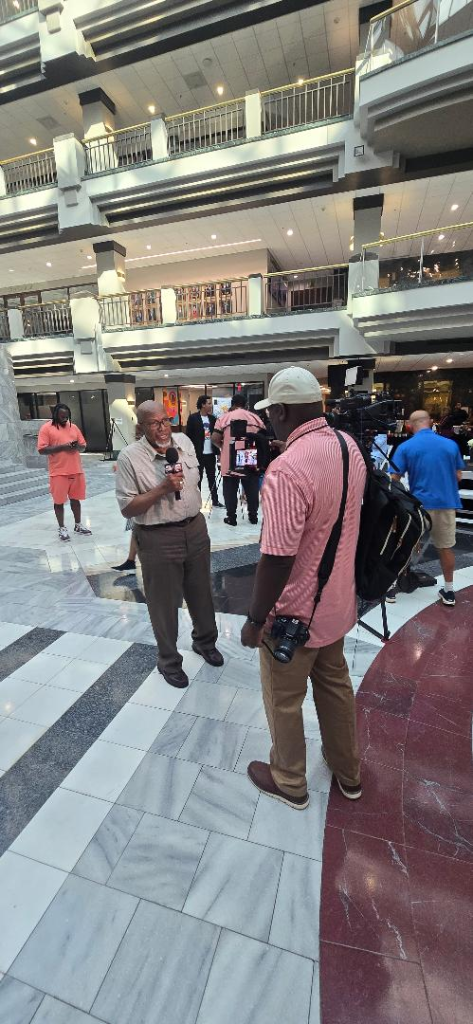 Media interview in the Atlanta City Hall Atrium lobby during the AMB Summit