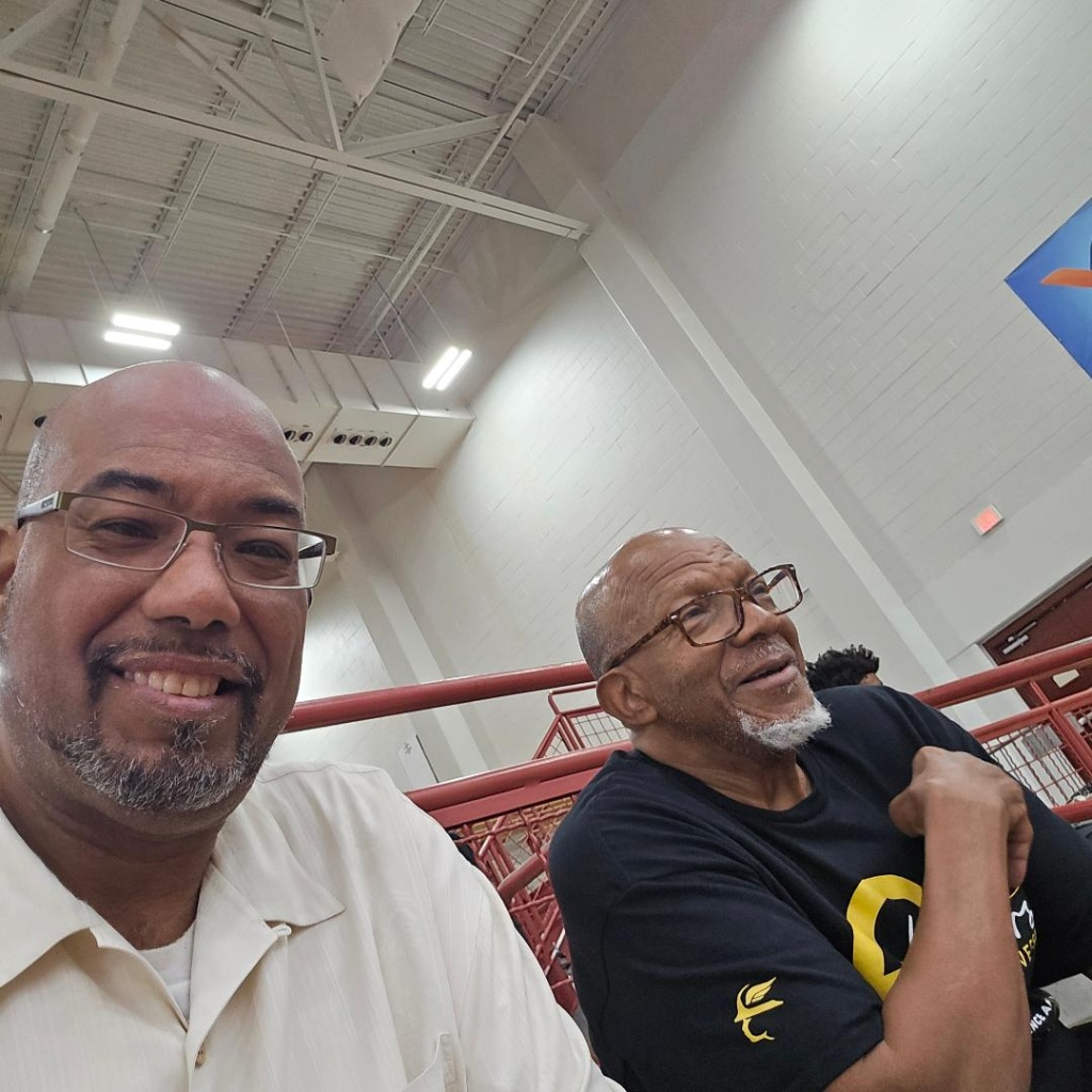 Two attendees share a moment inside Forbes Arena at Morehouse College during the AMB 40th Anniversary Games