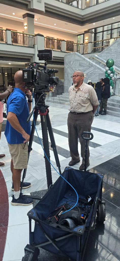 TV camera crew filming an interview at the AMB 40th Anniversary National Summit